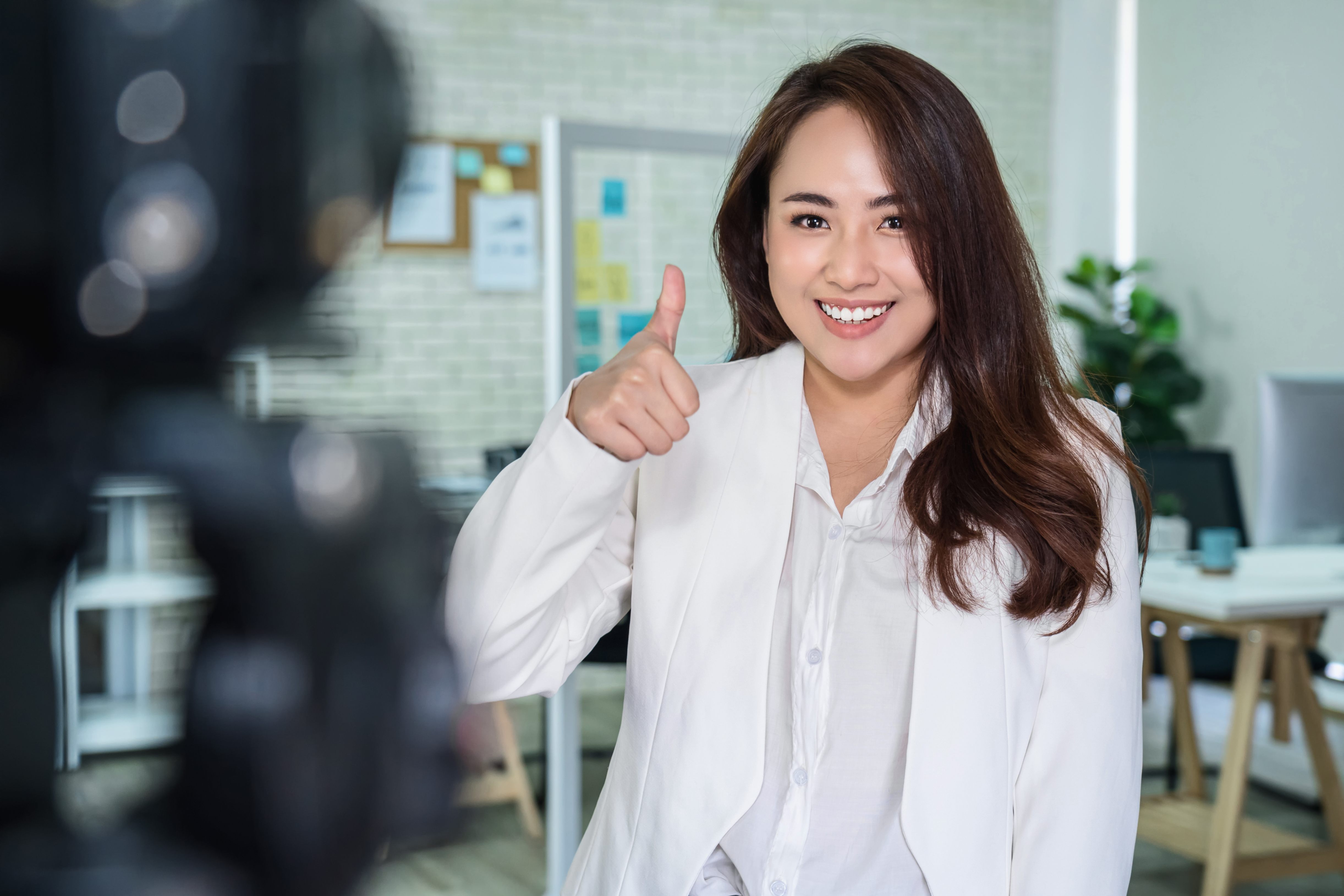 Person looking into camera doing thumbs up